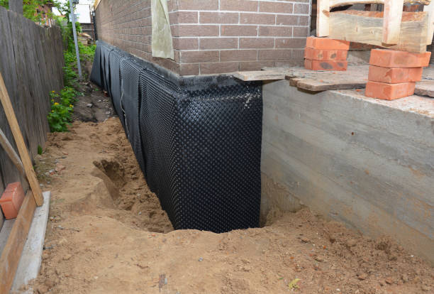 Happy homeowners after waterproofing job in Alger